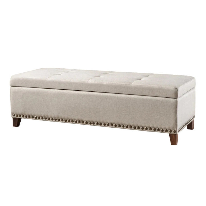Banc de rangement ottoman Nancy, 130 cm, tissu beige, bordure cloutée en laiton